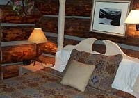The main bedroom within the two story log cabin.