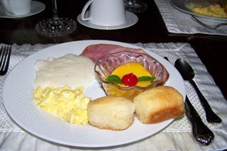 Breakfast included tea biscuits, country ham, eggs, grits, and fruit