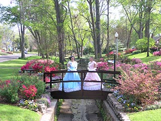 Young ladies attired in Antebellum Period clothing attend certain homes along the azalea trails in Tyler, Texas