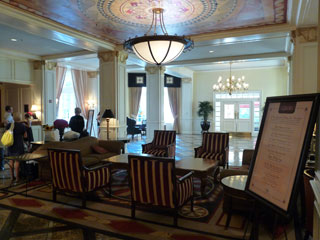 Lobby of the Warwick Melrose, with European influences, fresco ceiling, and large decorative columns. 
