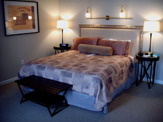 Magnolia Hotel suites are appointed with king size plush bed, kitchen, armoire, desk, bath, and large living room area