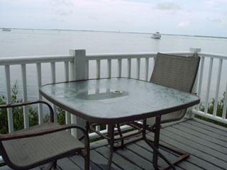 Relax and enjoy the island bay views on a waterfront lodge porch at the KOA